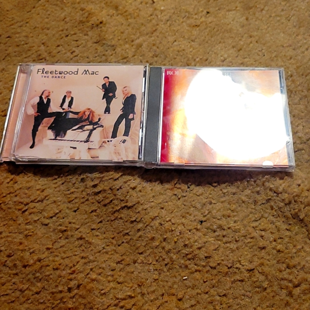 The Fleetwood Mac the dance CD music disc and the rod Stewart greatest hits disc